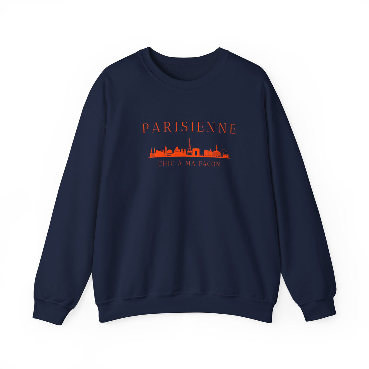 A navy crewneck sweatshirt with a bright orange “PARISIENNE” graphic, Paris skyline design, and “CHIC À MA FAÇON” text on the chest, displayed against a clean white background
