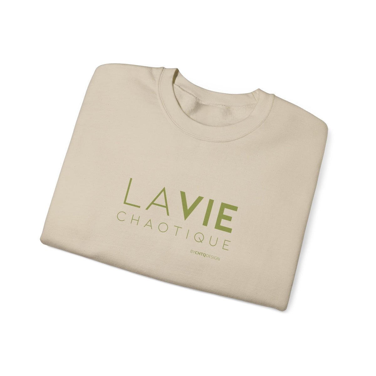 Folded beige crewneck sweatshirt with “LA VIE CHAOTIQUE” printed in olive green and “BY CHTQ DESIGN” beneath the graphic, displayed against a clean white background.