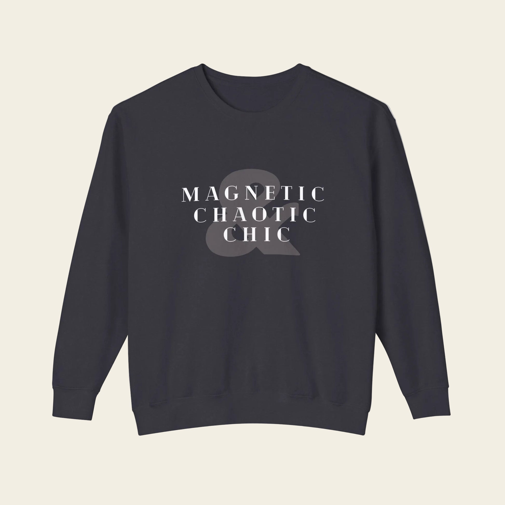 A dark navy crewneck sweatshirt with the phrase 'Magnetic Chaotic Chic' printed in white distressed capital letters across the chest