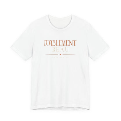 A white short-sleeve crewneck t-shirt with the words 'DIABILITY BEAUTY' printed on the chest in a muted rose-gold/copper tone, displayed against a solid white background.