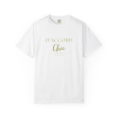A white short-sleeve crewneck t-shirt with 'D'ACCORD Chic' printed in a light olive green font on the chest, displayed against a solid white background.