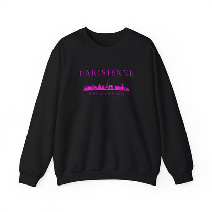 A black crewneck sweatshirt with a bright pink “PARISIENNE” graphic, Paris skyline design, and “CHIC À MA FAÇON” text on the chest, displayed against a clean white background.