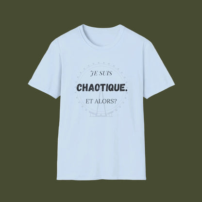 A light blue short-sleeve crewneck t-shirt with a black printed graphic on the chest reading 'JE SUIS CHAOTIQUE. ET ALORS?' inside a faint circular design, shown on a plain white background.