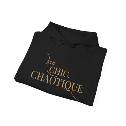 Folded black hoodie with frog graphic and 'Jolie. Chic. Chaotique' text on a white background