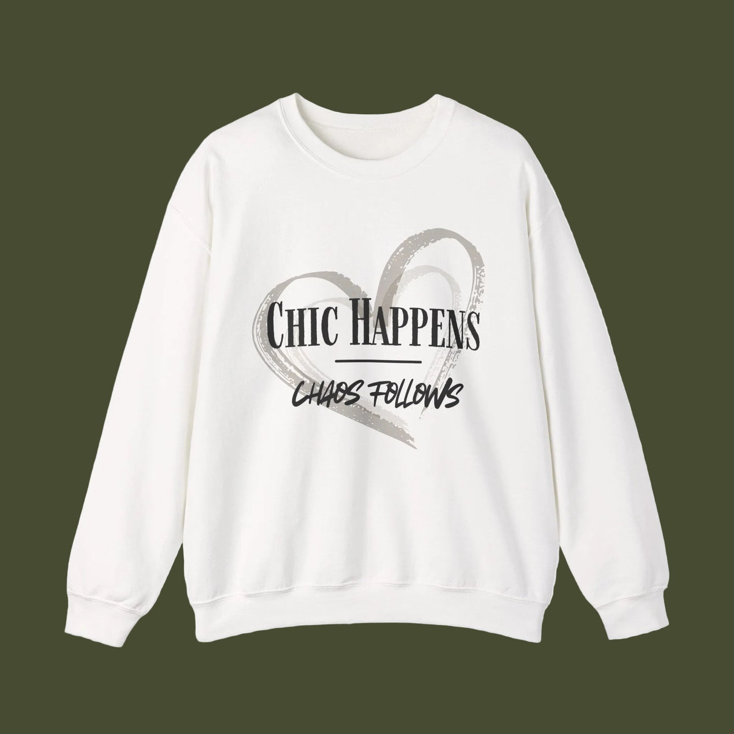An off-white crewneck sweatshirt featuring a graphic print on the front with a gray brushstroke heart and the text 'CHIC HAPPENS CHAOS FOLLOWS' in black and gray.