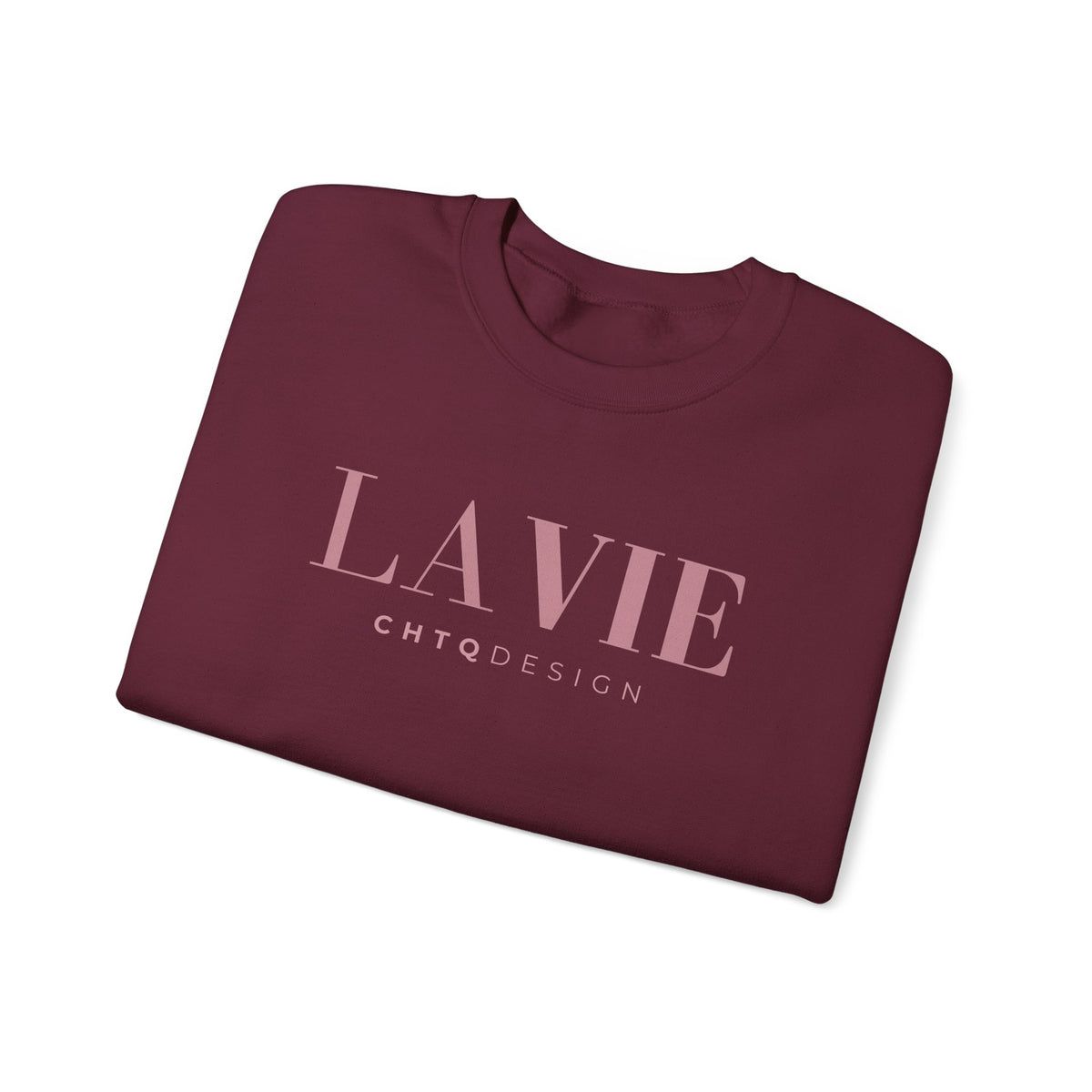 A folded maroon crewneck t-shirt with 'LA VIE' and 'CHTQDESIGN' printed in light pink on the front, displayed on a clean white background.