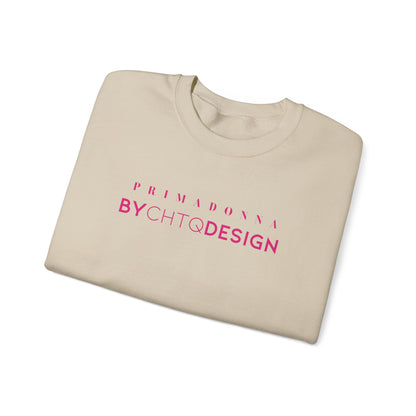 A folded beige crewneck sweatshirt featuring pink “PRIMADONNA BY CHTQ DESIGN” text across the chest, displayed against a clean white background.