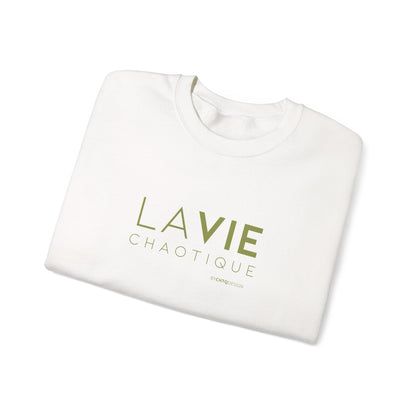 Folded off-white crewneck sweatshirt with “LA VIE CHAOTIQUE” printed in olive green and “BY CHTQ DESIGN” beneath the graphic, displayed against a clean white background.