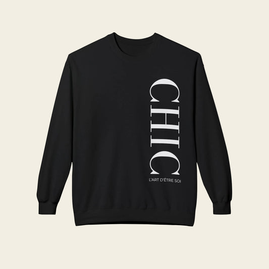 A black crewneck sweatshirt with a vertical white graphic print reading 'CHIC' and 'L'ART D'ETRE SCHIC' on the front, displayed against a solid white background.
