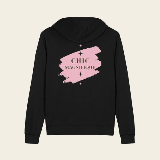 A black zip-up hoodie shown from the back, featuring a pink paint-stroke graphic with the words 'CHIC MAGNIFIQUE' in a gold serif font and small star accents.