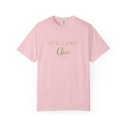A light pink short-sleeve crewneck t-shirt with 'D'ACCORD Chic' printed in gold on the chest, displayed on a clean white background.