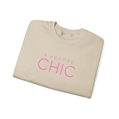 Folded Sand D’Accord Chic graphic crewneck sweatshirt with pink typography on the front, shown against a white background.