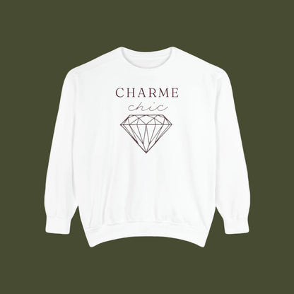 A white crewneck sweatshirt featuring a graphic print on the front with the text 'CHARME chic' and a black line art diamond illustration, displayed against a solid white background.