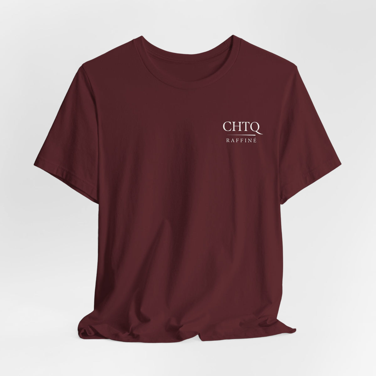 Maroon t-shirt with text CHTQ Raffine on the chest against a white background