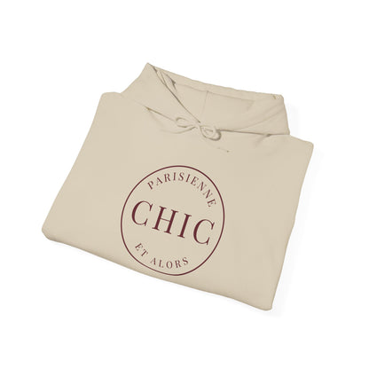 A folded beige hoodie with a circular dark red graphic on the front that reads 'PARISIENNE CHIC ET ALORS', shown on a clean white background.