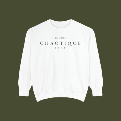 A white crewneck sweatshirt with black printed text reading 'JE SUIS CHAOTIQUE BEAU' on the chest, displayed against a solid white background.