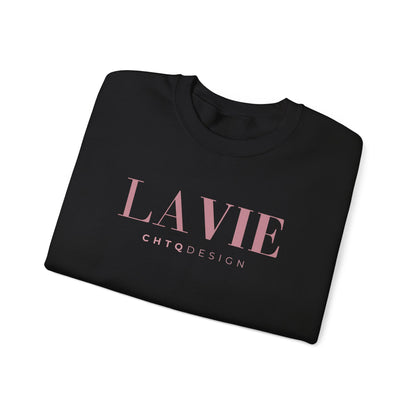 A folded black crewneck sweatshirt featuring a pink “LA VIE” graphic with smaller “CHTQ DESIGN” text underneath, displayed against a clean white background.