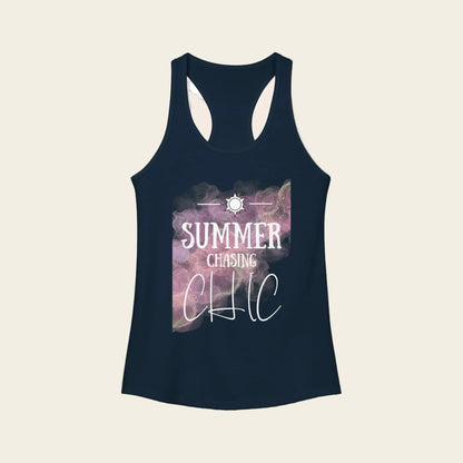 A navy blue racerback tank top with a graphic print on the front. The print features a purple and pink galaxy design with the text 'SUMMER CHASING CHIC' in white, along with a small sun icon at the top.