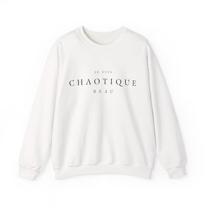 An off-white crewneck sweatshirt with 'JE SUIS CHAOTIQUE BEAU' printed in black serif text on the chest, displayed on a clean white background.