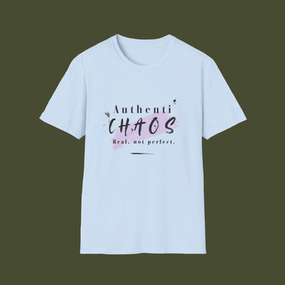 A light blue short-sleeve crewneck t-shirt with a graphic on the chest that reads 'AuthentiCHAOS Real, not perfect.' in black text over a pink watercolor splash, displayed on a clean white background.