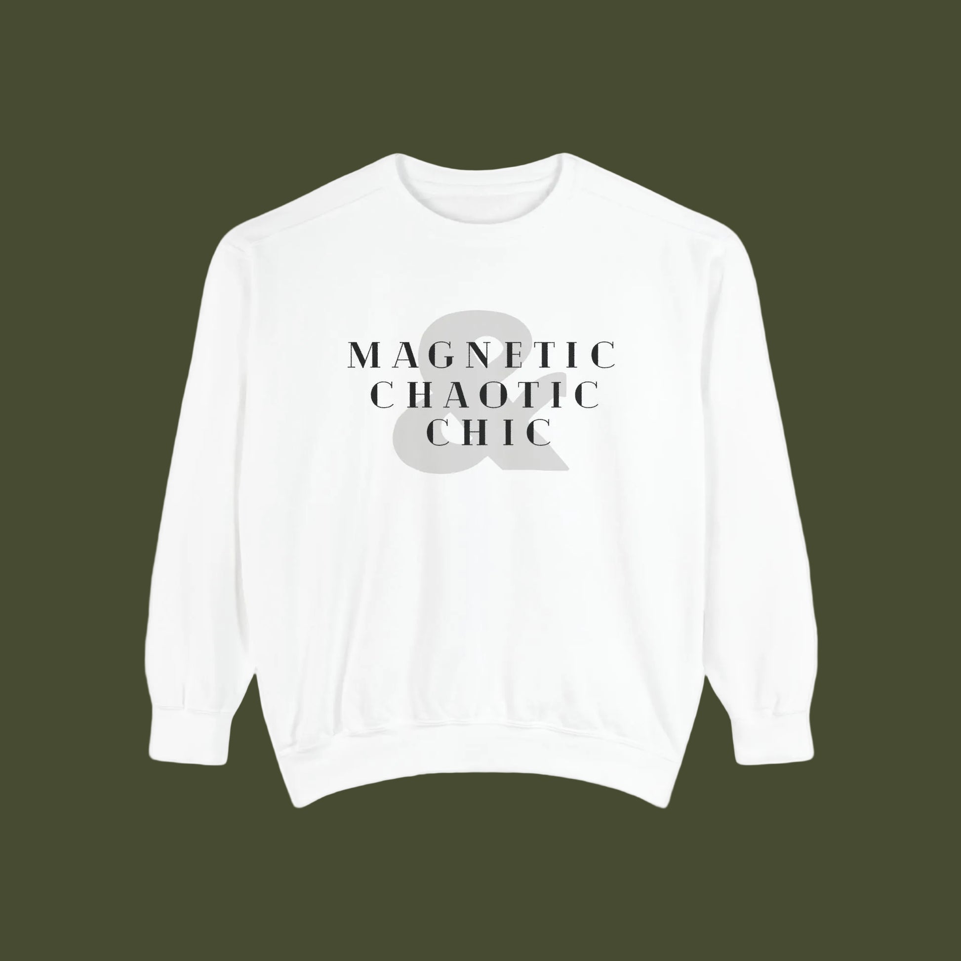 A white crewneck sweatshirt with a graphic print on the chest reading 'MAGNETIC CHAOTIC CHIC' in black serif text over a large gray ampersand symbol.