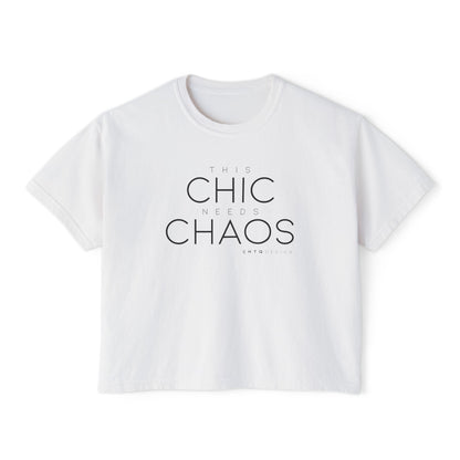 A white cropped graphic t-shirt with the text 'THIS CHIC NEEDS CHAOS' in black