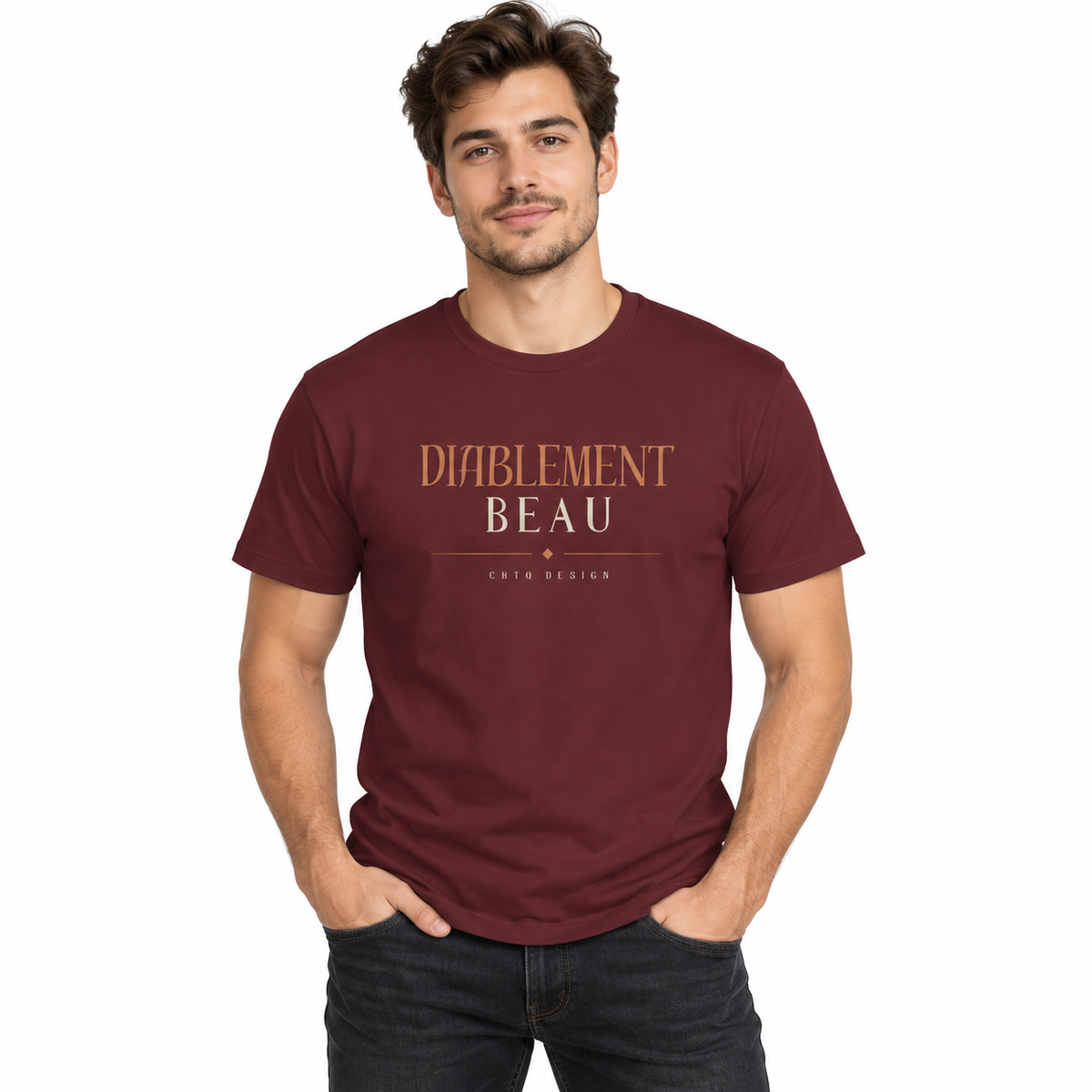 A man wearing a maroon crewneck t-shirt with 'DIABLEMENT BEAU' and 'CHTQ DESIGNS' printed on the chest, paired with light beige pants, against a plain white background.