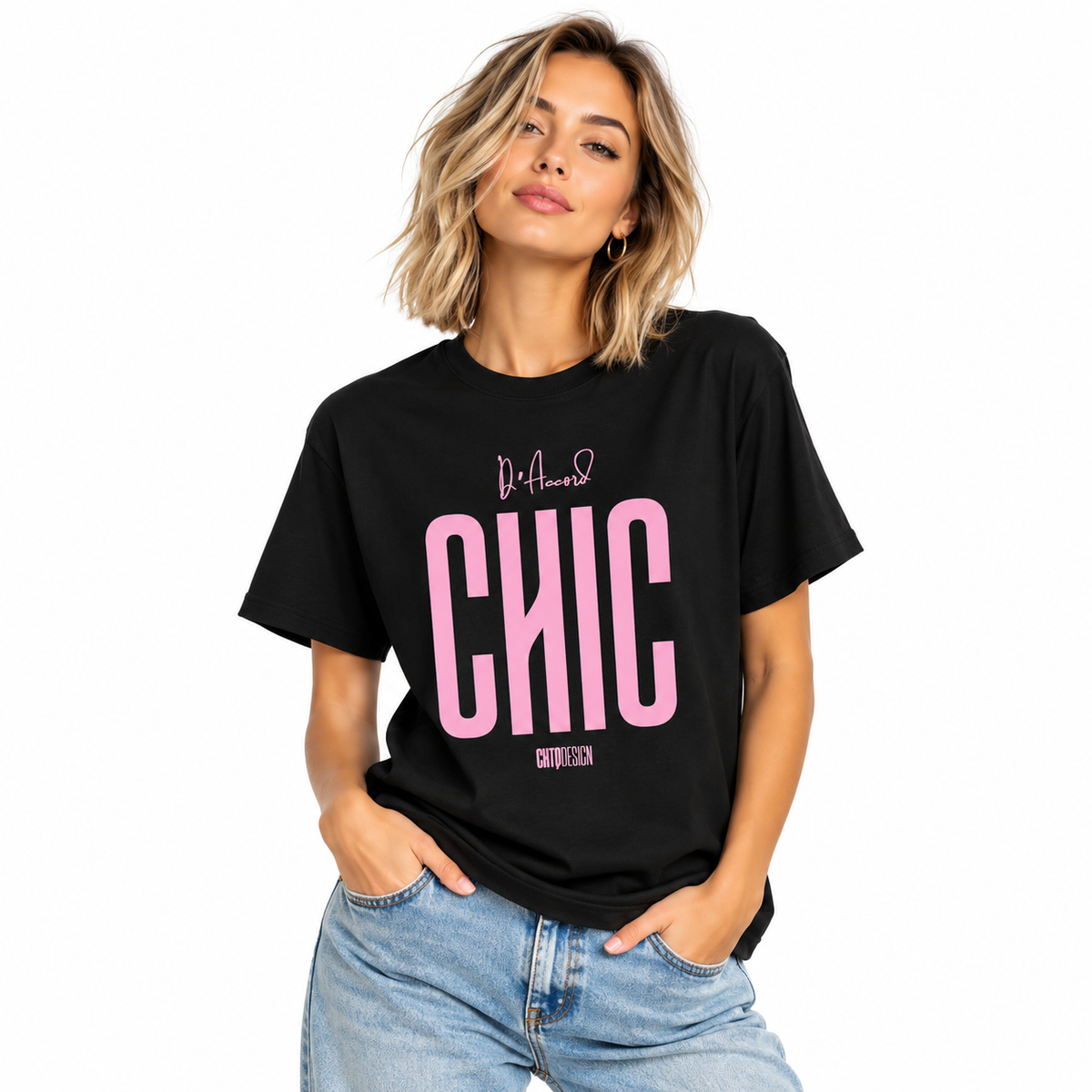 Young woman wearing a black D’Accord CHIC graphic T-shirt with light pink lettering and blue jeans.