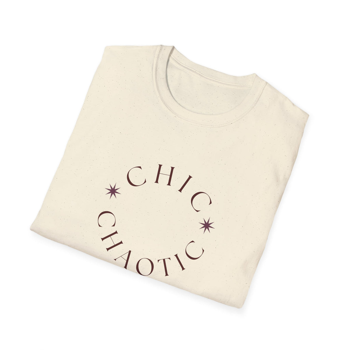 A folded cream-colored cotton t-shirt with a dark purple graphic print that reads 'CHIC CHAOTIC' in an arc with two star accents, displayed on a clean white background.