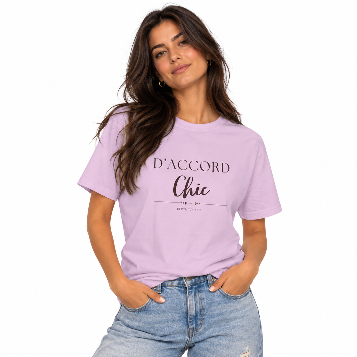A woman modeling a light purple graphic t-shirt with the text 'D'ACCORD Chic' printed on the front, paired with light-wash blue jeans against a solid white background.