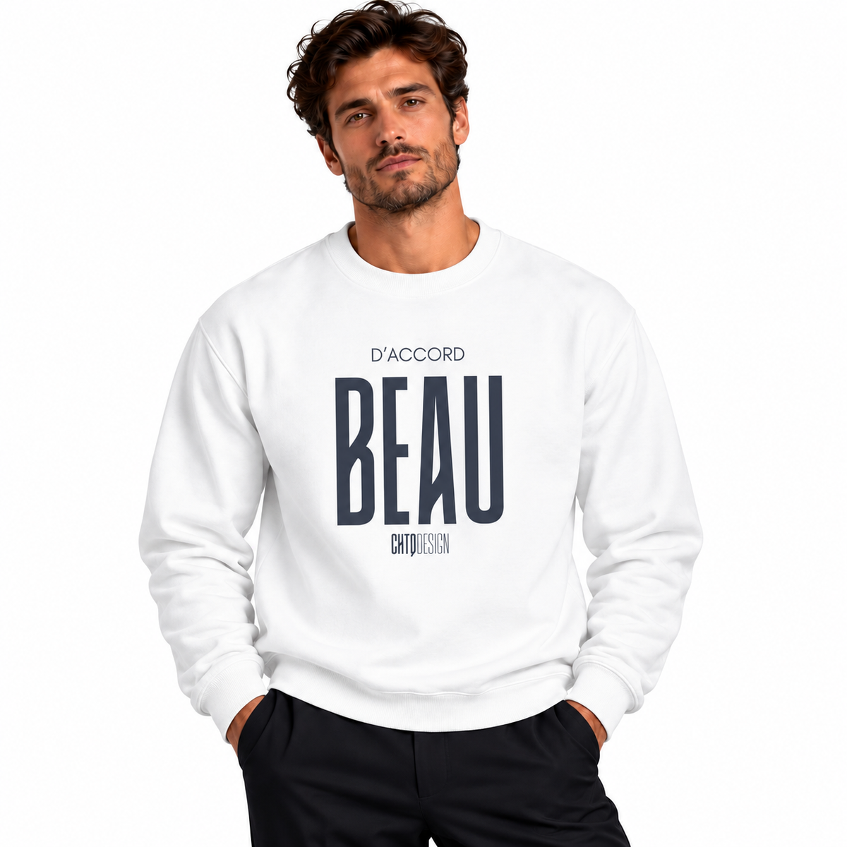 Male model wearing a white D’Accord BEAU graphic crewneck sweatshirt with black trousers against a white studio background.
