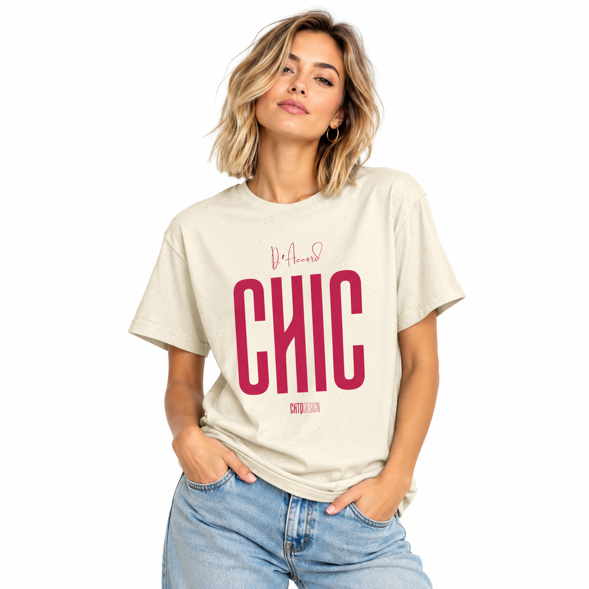 Young woman wearing a natural cream D’Accord CHIC graphic T-shirt with raspberry pink lettering and blue jeans.