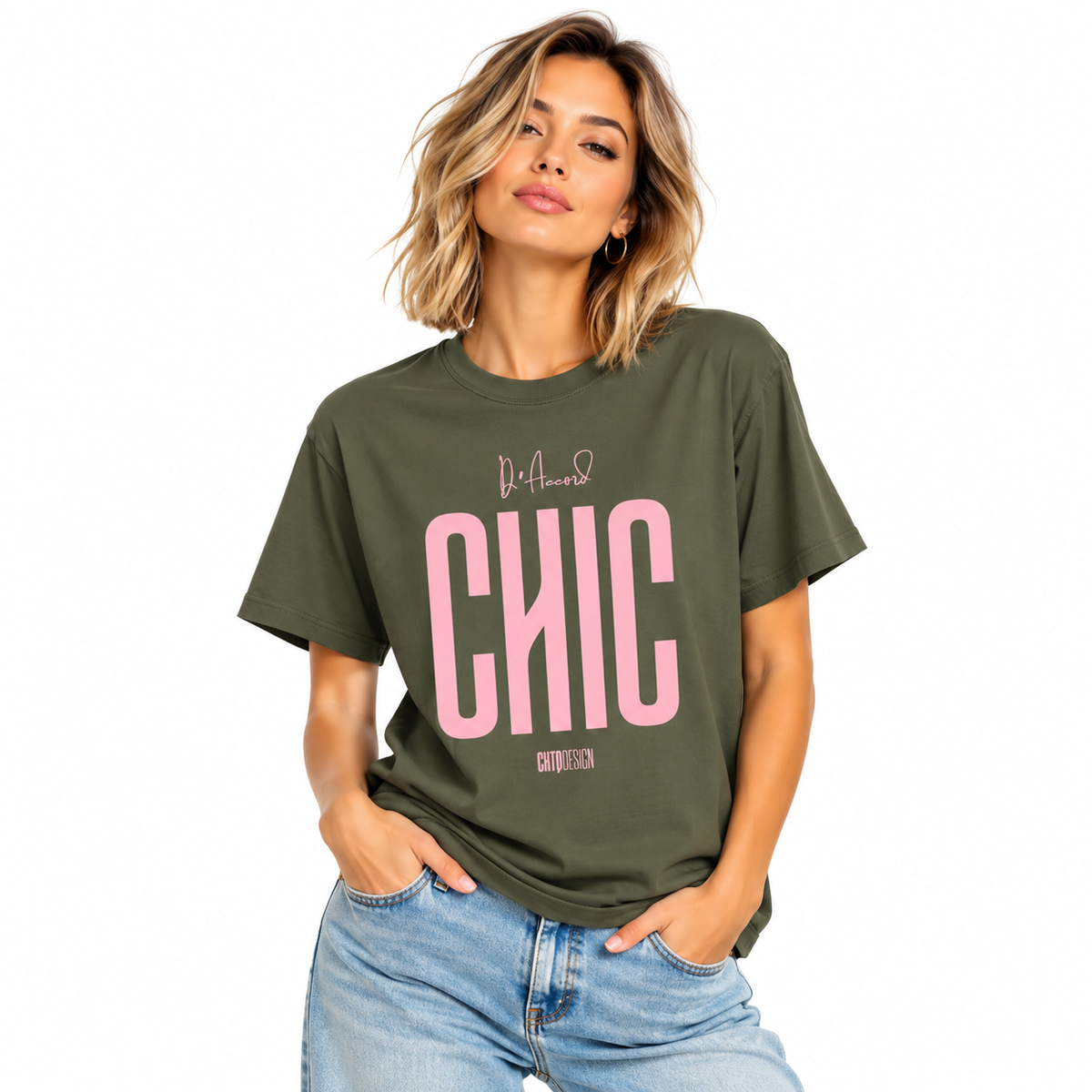 Young woman wearing a military green D’Accord CHIC graphic T-shirt with light pink lettering and blue jeans.