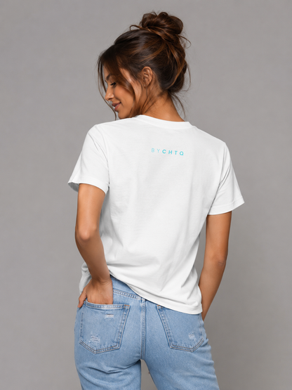 A woman wearing a white short-sleeve T-shirt shown from the back, featuring a small light blue 'BY CHTQ' detail below the neckline, paired with light-wash jeans against a neutral gray studio background.