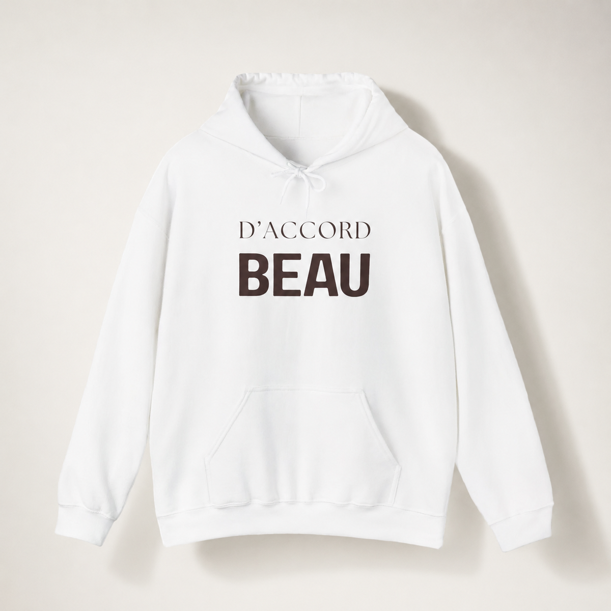 White D’Accord Beau pullover hoodie featuring dark brown typography on the front, displayed against a soft off-white studio background.