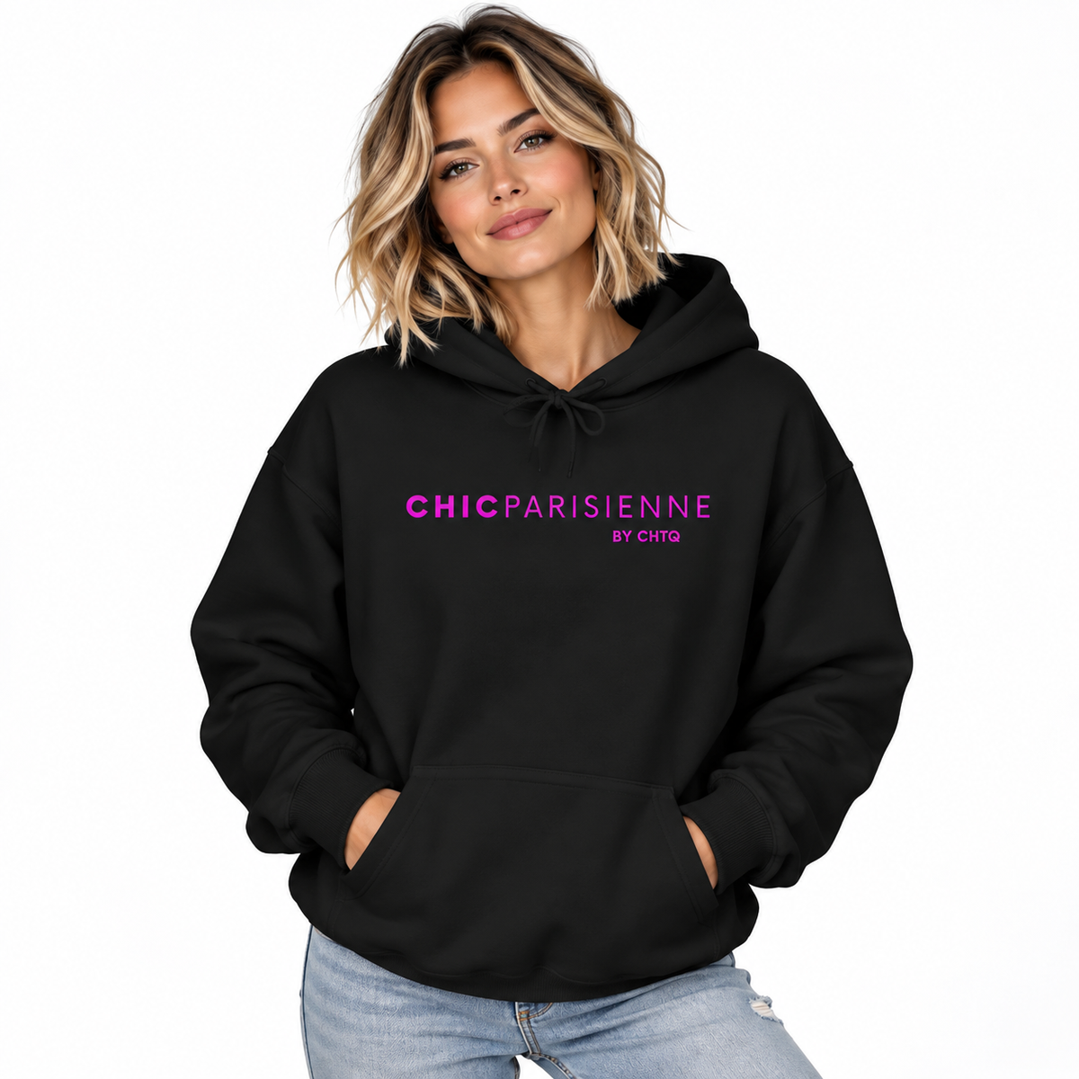 A woman wearing a black pullover hoodie with 'CHICPARISIENNE BY CHTQ' printed in pink across the chest, paired with light blue jeans, set against a plain white background.