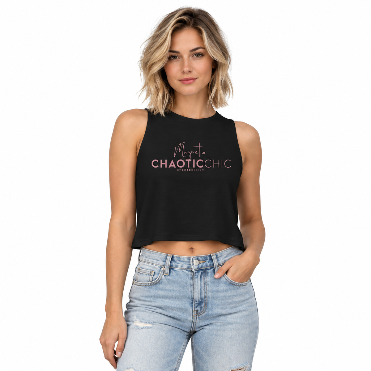 A woman modeling a black sleeveless crop top with 'Magnetic ChaoticChic' printed in pink and white text, paired with light-wash distressed jeans against a plain white background.