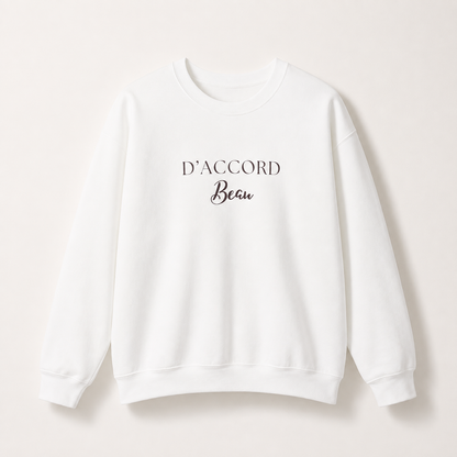 White D’Accord Beau crewneck sweatshirt featuring dark brown typography on the front, displayed against a light studio background.