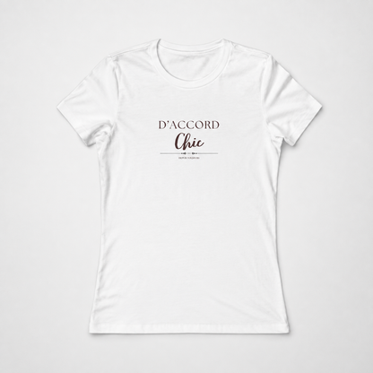 White short-sleeve crewneck T-shirt featuring the “D’Accord Chic” graphic in black and brown lettering on the front, displayed against a light gray background.
