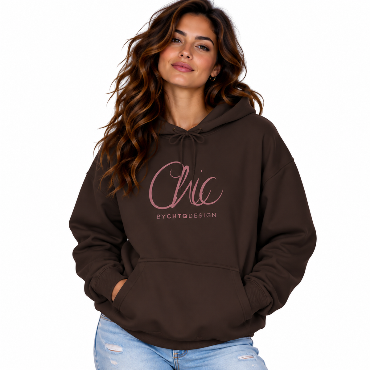 A woman wearing a dark brown pullover hoodie with a pink 'Chic' and 'BY CHTQ DESIGN' graphic on the chest, paired with light blue jeans, set against a plain white background.