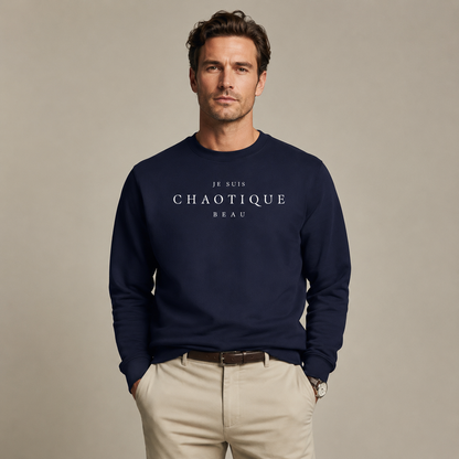 Man wearing a navy Je Suis Chaotique Beau sweatshirt with beige trousers in a minimalist editorial studio setting