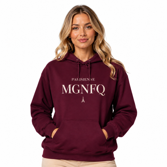 A woman wearing a burgundy PARISIENNE MGNFQ graphic hoodie with cream typography, posing against a neutral gray studio background.