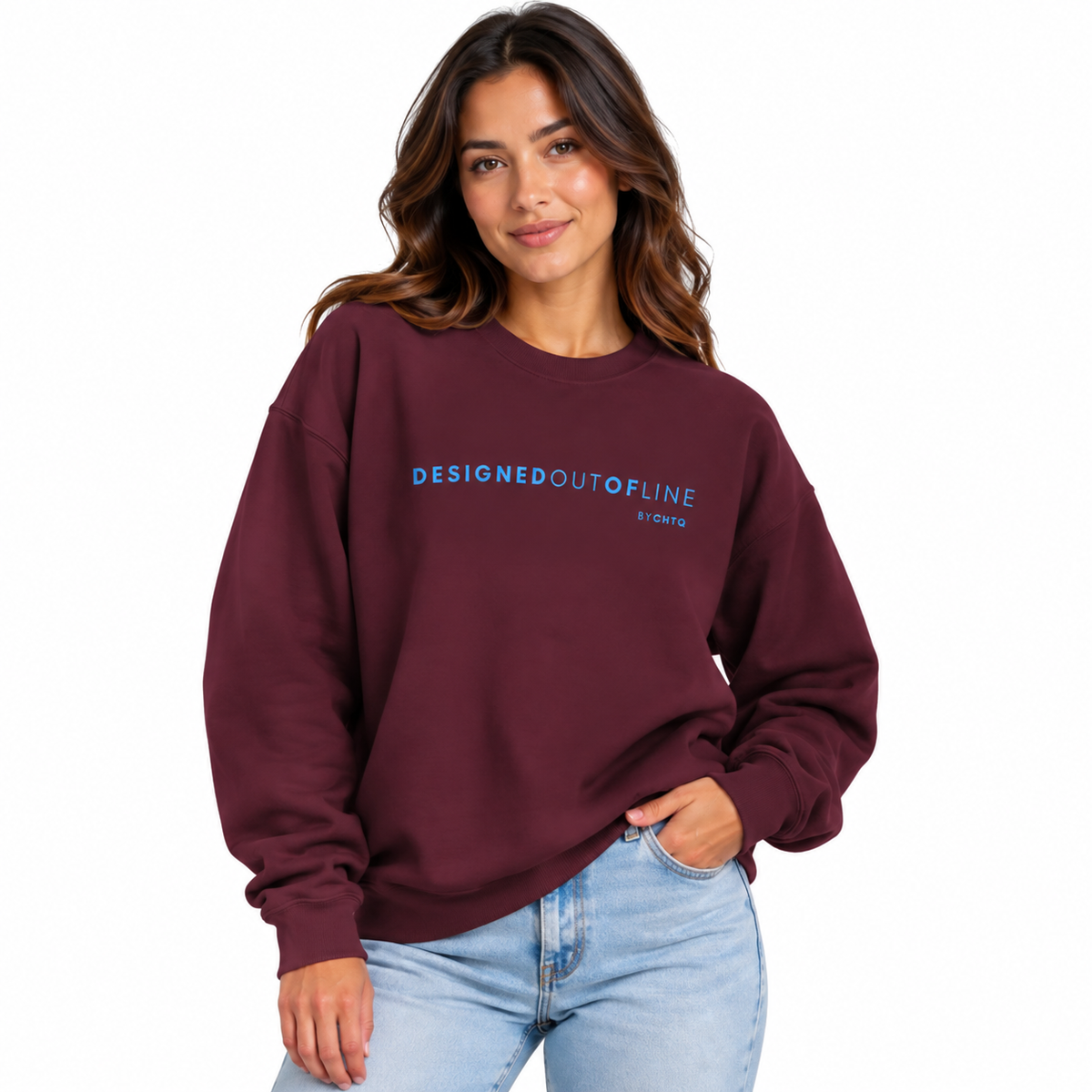 A woman wearing a maroon crewneck sweatshirt with 'DESIGNEDOUTOFLINE By CHTQ' printed in blue across the chest, paired with light blue jeans, against a plain white background.