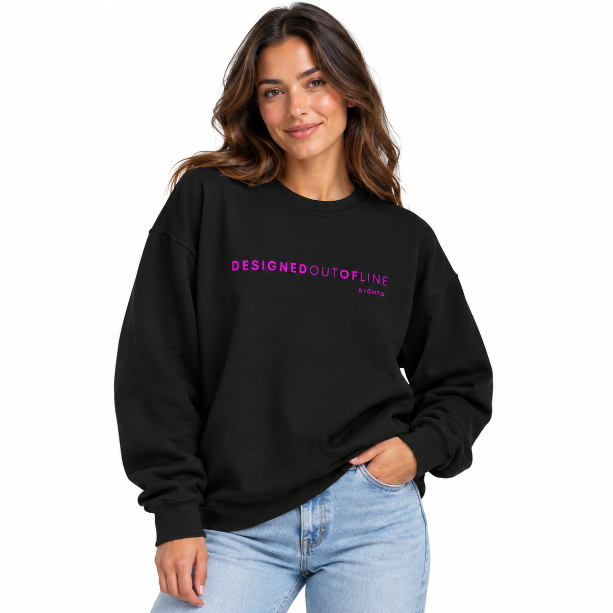 A woman wearing a black crewneck sweatshirt with 'DESIGNEDOUTOFLINE BYCHTQ' printed in pink across the chest, paired with light blue jeans, against a plain white background.