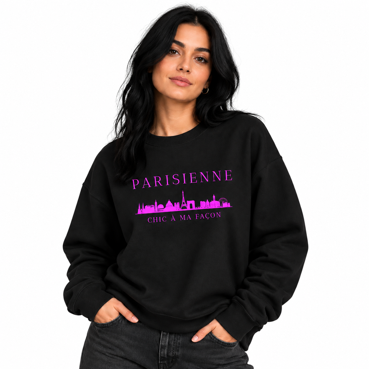A woman modeling a black crewneck sweatshirt with a purple graphic print that reads 'PARISIENNE' and 'CHC A MA FACON' with a skyline silhouette, set against a plain white background.