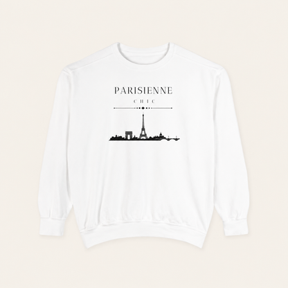 White crewneck sweatshirt featuring the “Parisienne Chic” graphic with a black Paris skyline on the front, displayed against a light beige background.
