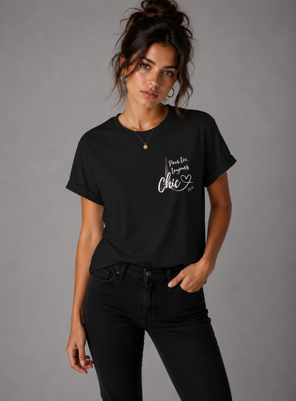 Woman wearing a black Pour Toi, Toujours Chic graphic T-shirt with black jeans in a minimalist gray studio setting.