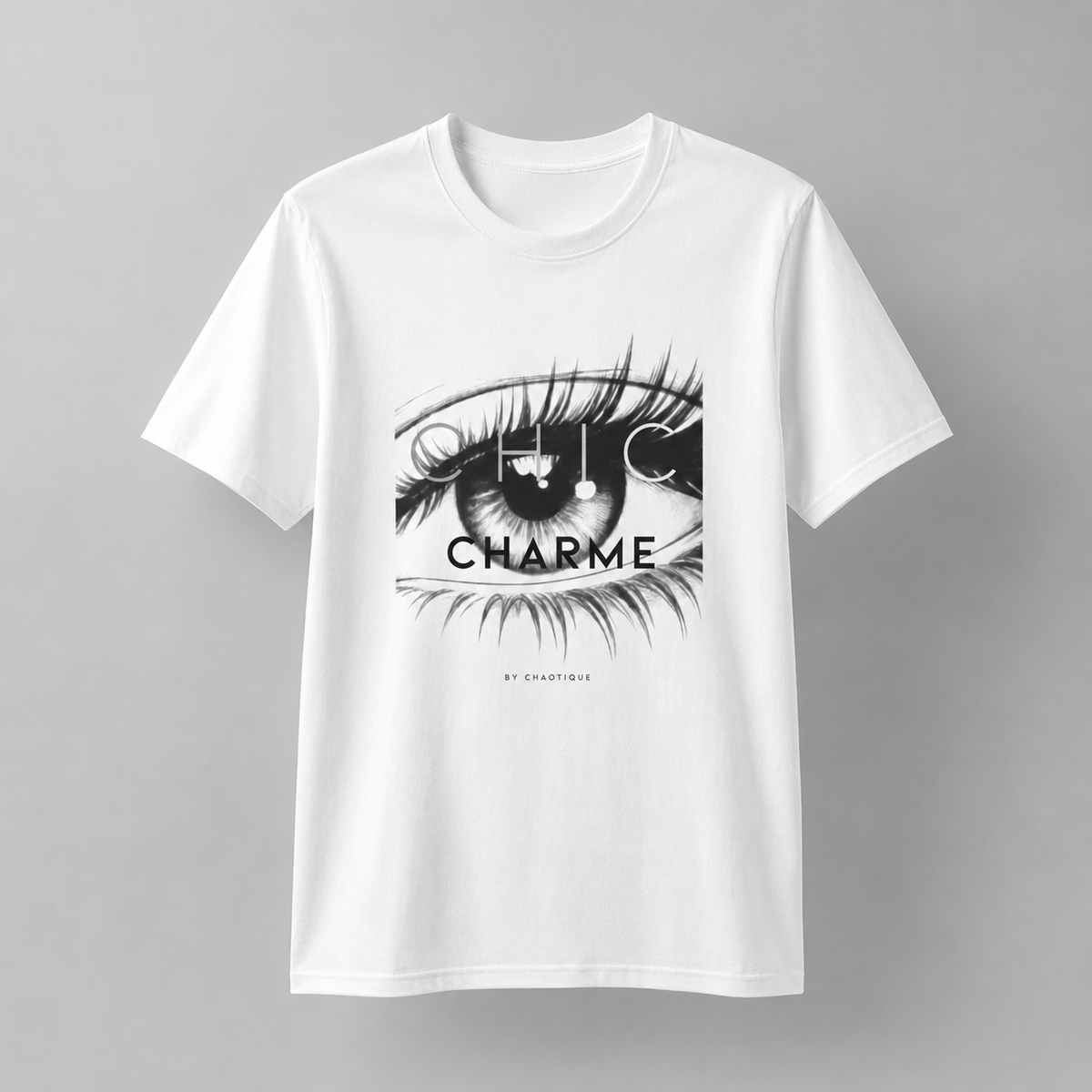 White CHIC CHARME graphic T-shirt featuring a bold black-and-white eye print with minimalist typography.